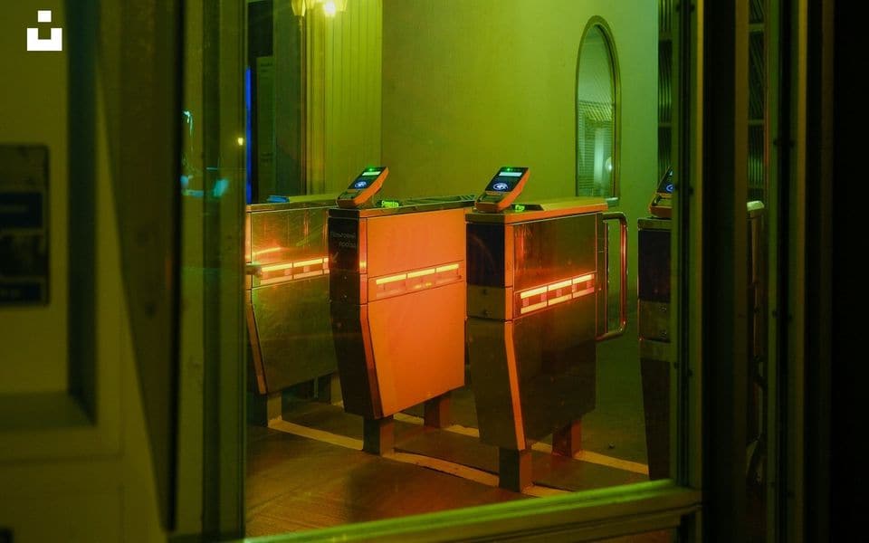 Modern entrance speed gates illuminated with directional LED indicator lights