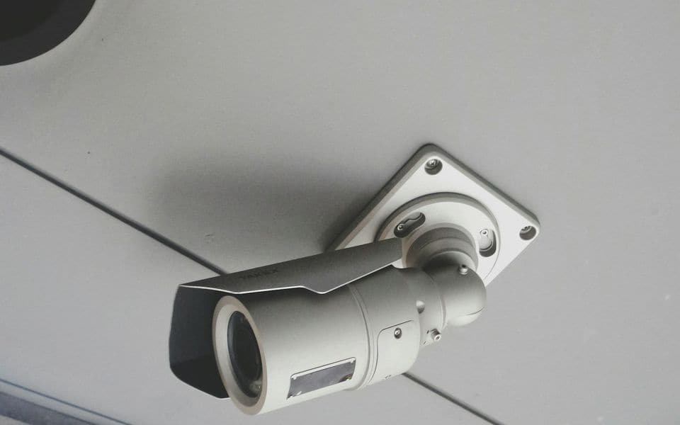 Dome surveillance camera mounted flush onto commercial acoustic ceiling tiles