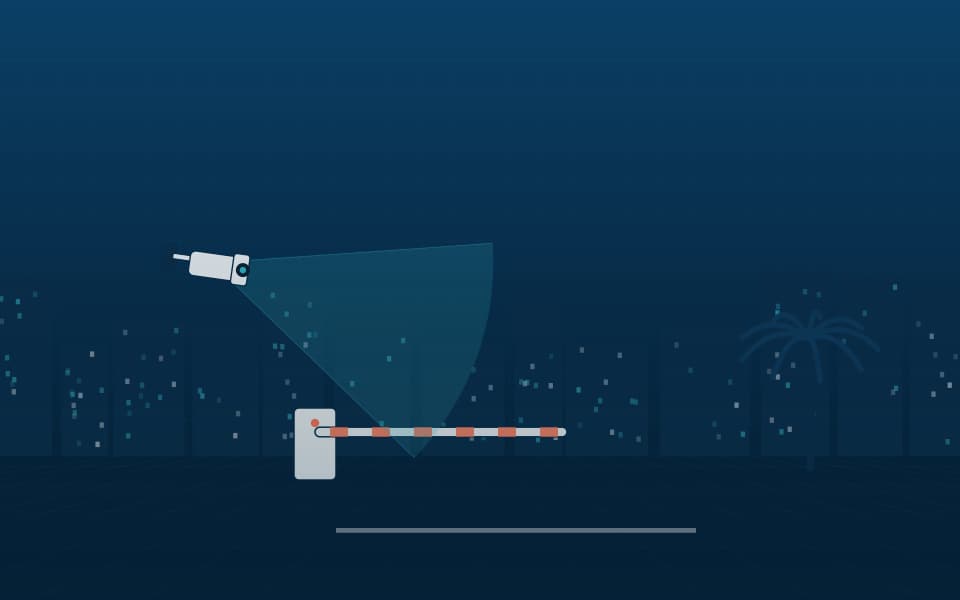 Vehicle barrier with an ANPR camera at a site entrance, at night