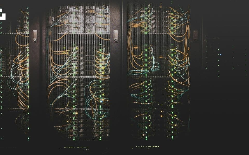 Server room network equipment racks with structured patch cabling and status indicator lights