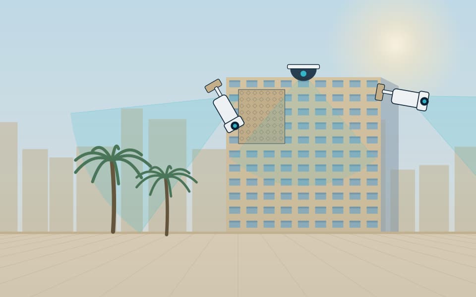 Building facade with external cameras covering the approaches, in daylight