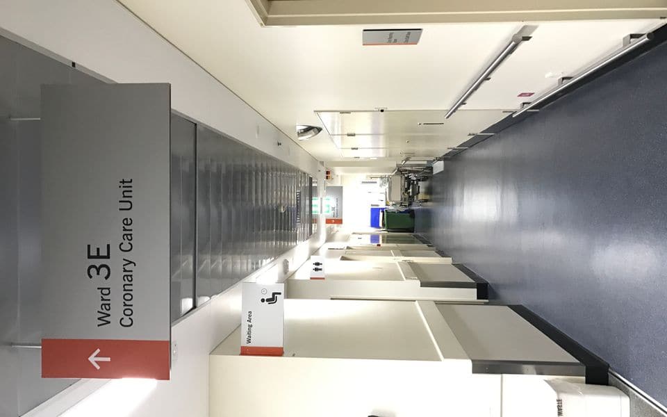 A hospital corridor with a ward sign