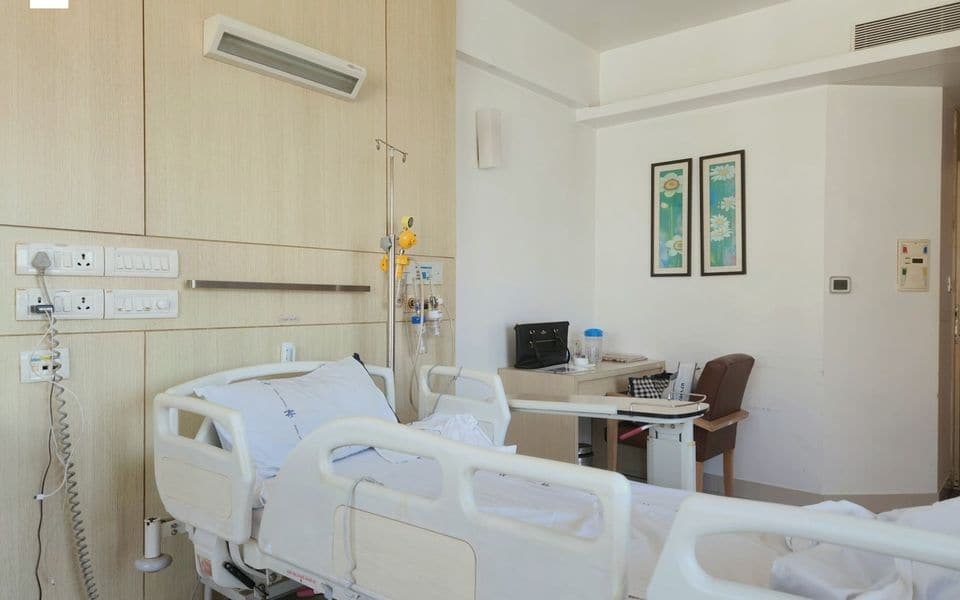 Modern hospital patient room interior with bed and medical desk