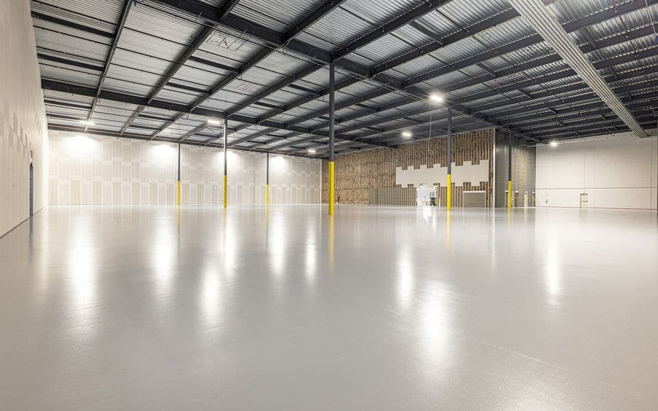 Modern logistics warehouse facility interior with polished concrete floor