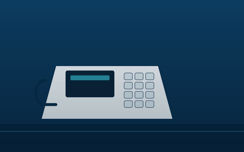 IP desk phone on a reception desk (detail), at night